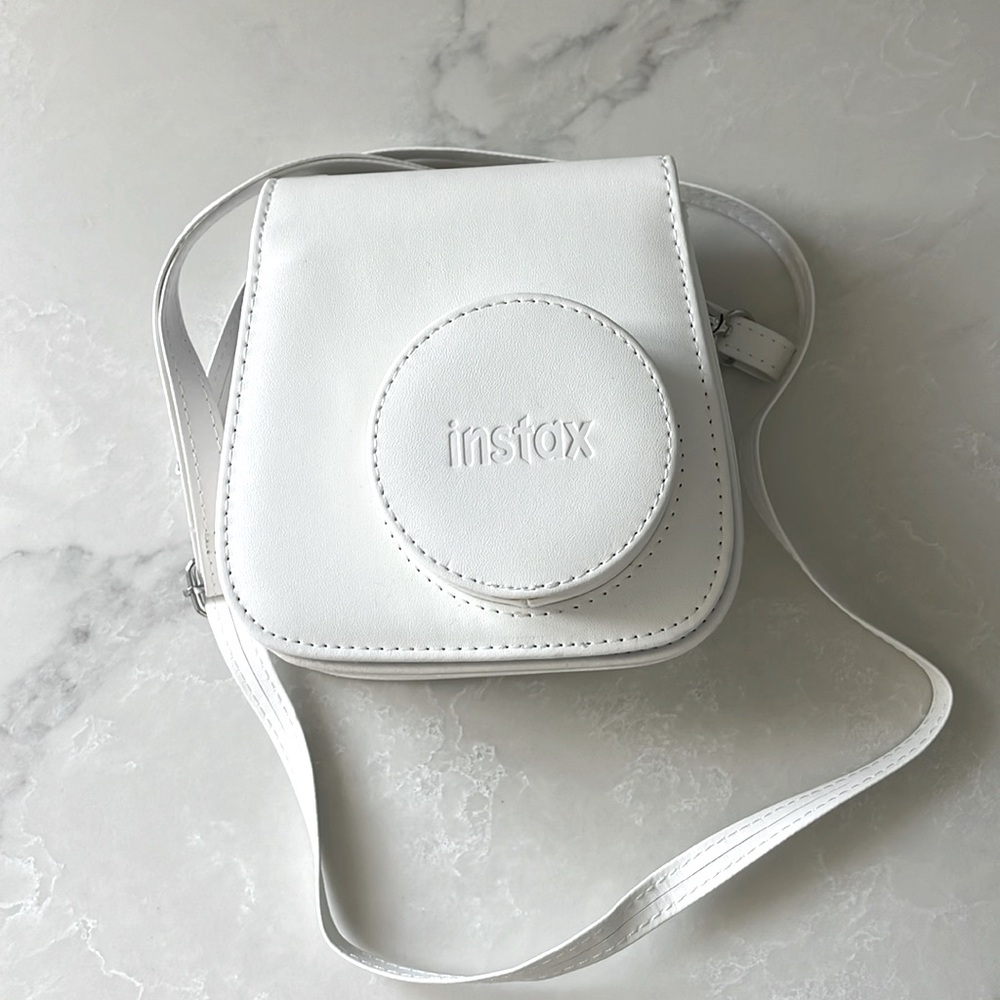 Used a handful of times Instax camera case in bright white. Excellent condition.